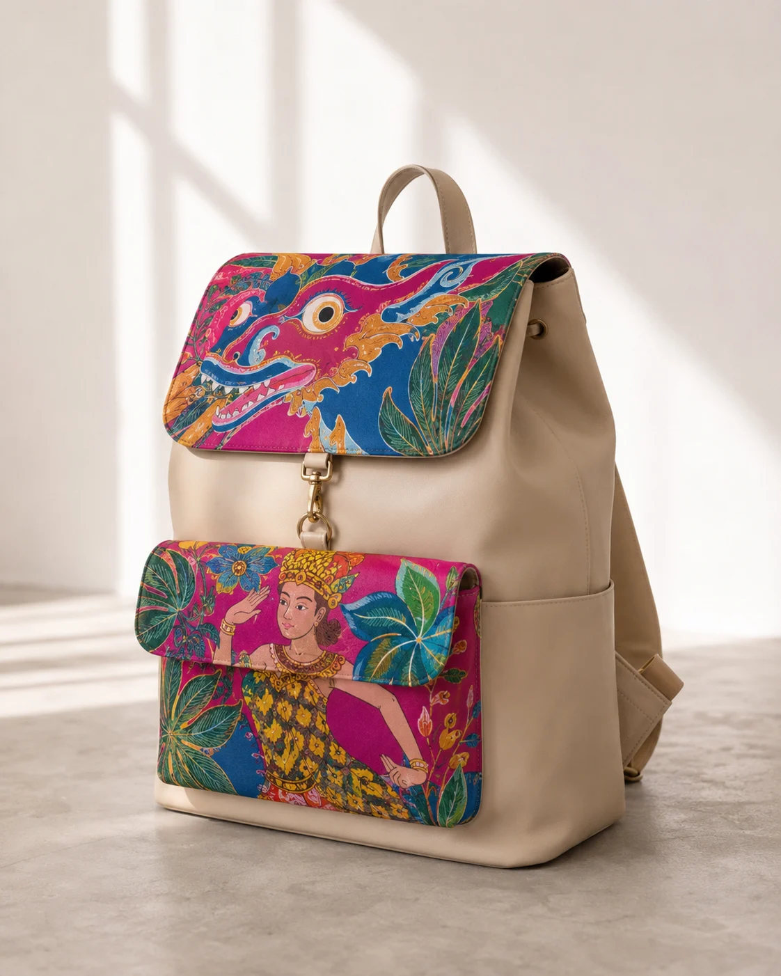 Cream backpack with vivid dragon and dancer artwork presented alone in directional daylight